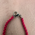 close up of pink enamel chain clasp
